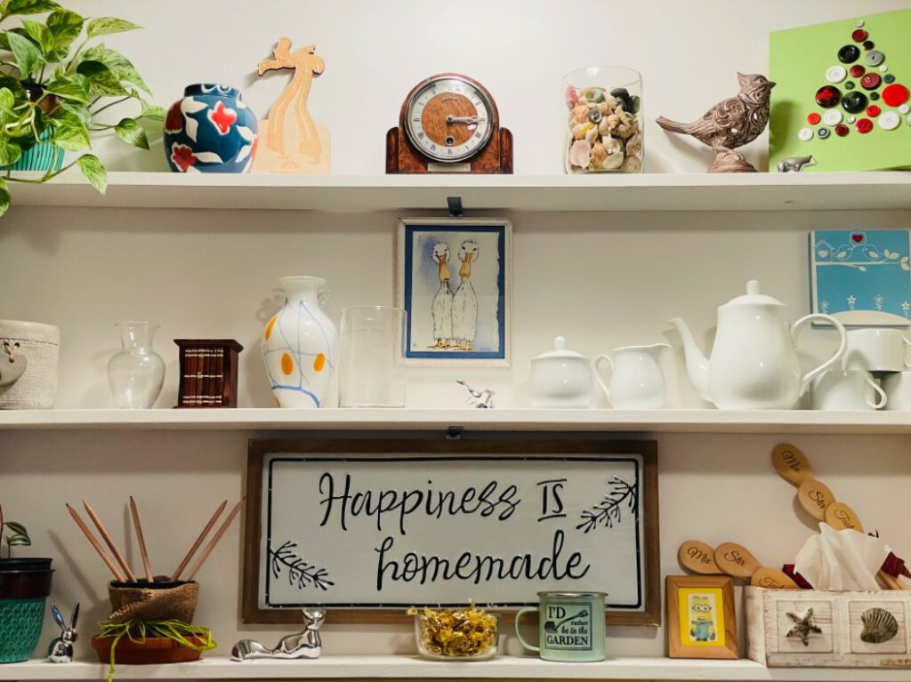 View of shelving unit with several knickknacks on each shelf